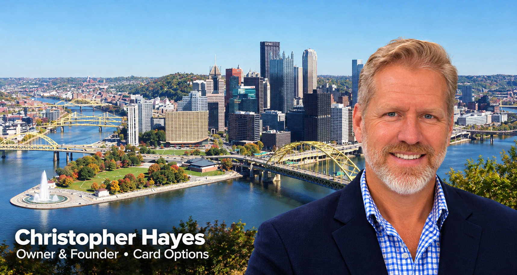 Christopher Hayes, Owner and Founder of Card Options, with the daytime Pittsburgh skyline and autumn foliage behind him